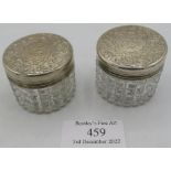 A pair of Victorian silver lidded glass jars, approx 1/2" high. The lids have engraved decoration