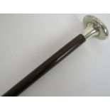 An early 20th century walking cane with hallmarked silver handle, (London 1916) inset with two