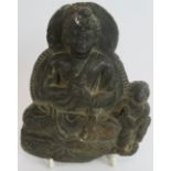 An antique Indo-Greek carved hardstone figure of a seated Buddha with a praying attendant. Indian