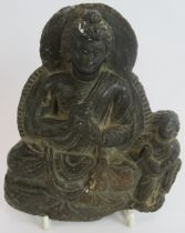 An antique Indo-Greek carved hardstone figure of a seated Buddha with a praying attendant. Indian