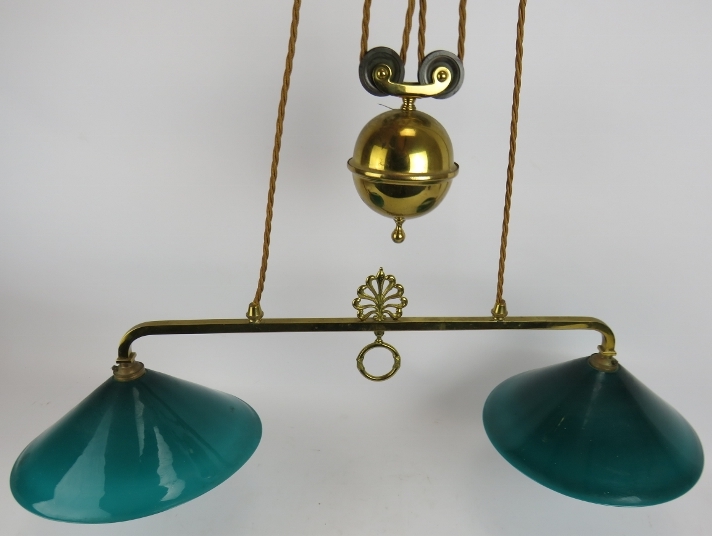 A period brass two lamp rise and fall ceiling light with Emeralite green glass shades. Width 78cm.