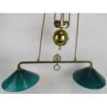 A period brass two lamp rise and fall ceiling light with Emeralite green glass shades. Width 78cm.