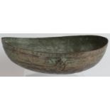 A finely decorated Omani copper Kashkul begging bowl with intricately chased patterns and silvered