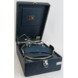 A vintage portable HMV gramophone in blue leatherette case. 41cm x 29cm. Condition report: Winds and