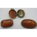 An oval vintage amber pendant/brooch, approx 25mm x 40mm, an agate brooch and a double sided agate