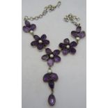 An unusual amethyst and split pearl white metal necklace. The collet set amethysts arranged in a