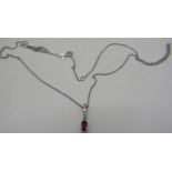 A white metal small ruby and five small diamond pendant on a fine 9ct white gold chain. Ruby