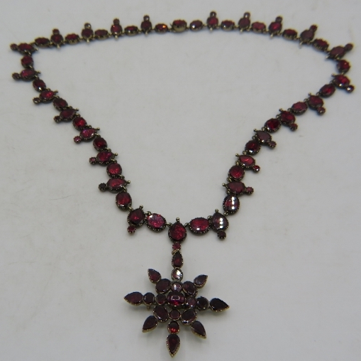 A fine antique Riviere amethyst necklace with amethyst star burst pendant. Pendant probably added at