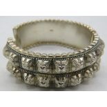 A Victorian silver stud bangle, Birmingham 1882, boxed. Approx weight 41 grams. Condition report: