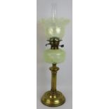 A fine quality brass French oil lamp on reeded column, green Art Nouveau glass reservoir and