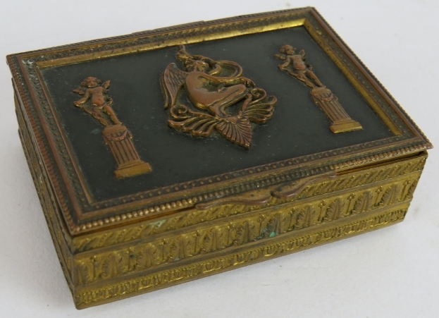 A small French Empire Revival gilt brass trinket box with green velvet lining. 8cm x 6cm x 2.5cm.