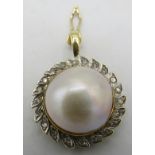 An 18ct yellow gold hinged pendant set with centre Mabe pearl, approx 15mm across with 21 small