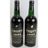 Two bottles of Croft vintage port 1963. (2). Condition report: One level top shoulder, one level