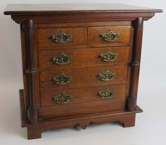 A small set of antique oak drawers/collectors cabinet. Possibly an apprentice piece. Height 38cm.