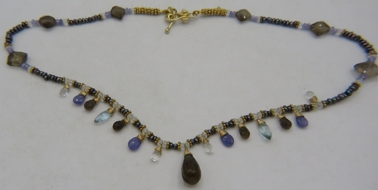 A delicate vermeil fringe necklace set with various semi-precious stones & pearls, including