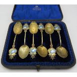 A set of decorative gilded Bermudian teaspoons with enamelled fish and crown decoration. Approx