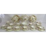 An ornate antique 31 piece tea set decorated with flowers and gilt edges. (31). Condition report: