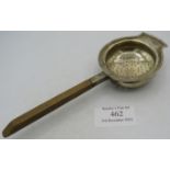 A silver tea strainer with wooden handle, Birmingham 1910. Approx weight 1.3 troy oz/42 grams.