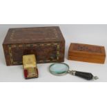 A cigar humidor, an inlaid cigarette box, a leather bound magnifying glass and a vintage Ronson
