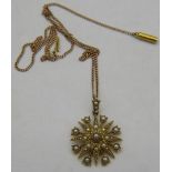 A yellow metal star shaped pendant set with seed pearls on a 15ct yellow gold fine link chain,