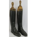 A pair of vintage black leather riding boots with beech wood boot trees. Height 63cm. (pr).