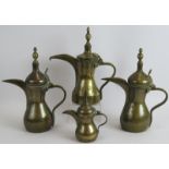 Four middle Eastern brass Dallah coffee pots one with stamped decoration. Tallest 31cm. Condition