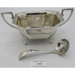 A heavy two handled silver sugar bowl on paw feet, Sheffield 1938 and a silver sugar sifter spoon,