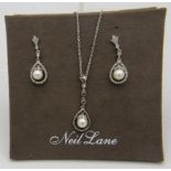A Neil Lane silver, pearl & diamond pendant with matched drop earrings. The pearls suspended in a