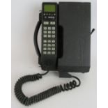 A 1980s Bosch CP007 car phone with mounting bracket. Condition report: Untested. Sold as seen.