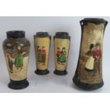 Four Bretby pottery vases each hand decorated over relief traditional Dutch scenes. Tallest 32.