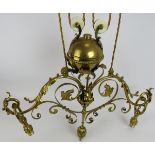 A period brass Art Nouveau two lamp rise and fall ceiling light with acanthus leaf decoration. Width