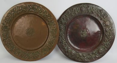 Two beaten copper Arts & Crafts chargers in the style of Keswick School of Industrial Arts. Each