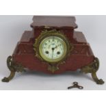 An antique French red marble mantle clock with enamelled dial and gilt brass mounts. Note: the