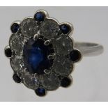A superb 18ct white gold cluster ring set with centre sapphire, approx 8mm x 6mm, surrounded by 8