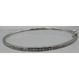 An 18ct white gold bangle with one half set with a band of diamonds. Diamonds approx 1ct, double