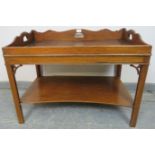 A Georgian design mahogany butler’s tray coffee table with shaped ¾ gallery, on inner chamfered