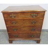A Georgian mahogany chest of small proportions, housing four long graduated cock-beaded drawers with