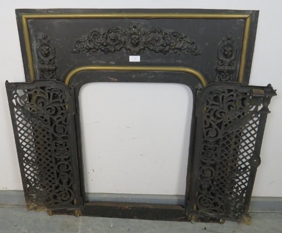 An antique cast iron and brass fireplace insert, the applied decoration depicting scrolling acanthus - Image 2 of 4