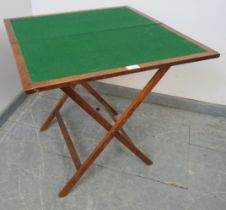 A 19th century mahogany folding campaign card table, with cast iron fittings, the canvas straps