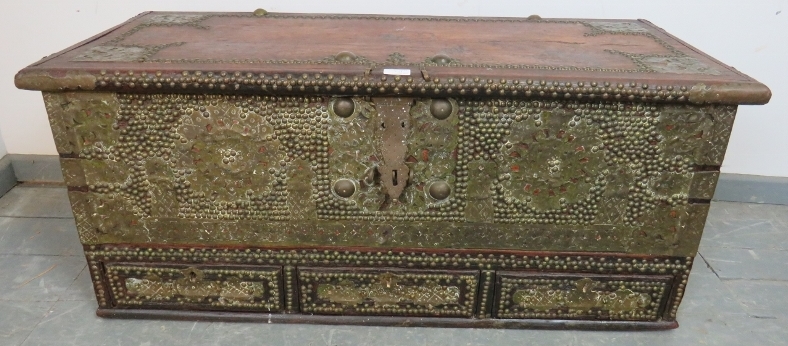 A 19th century hardwood Zanzibar chest, featuring pierced brass decoration and a multitude of