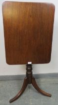 A Victorian mahogany rectangular tilt-top wine table, on a baluster turned column with splayed