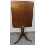 A Victorian mahogany rectangular tilt-top wine table, on a baluster turned column with splayed