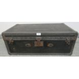 An antique travelling trunk by Malles Goyard of Paris, bound with leather strapwork and brass studs,