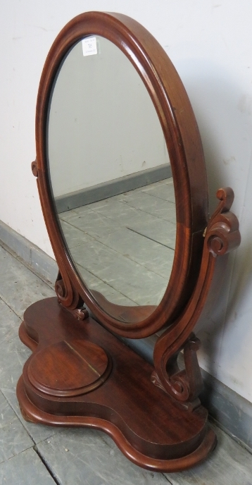 A Victorian mahogany oval swing vanity mirror, with scrolled and pierced uprights, on a shaped - Image 2 of 3