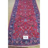 North West Persian Sarouk runner. Central foliage on claret ground and repeat blue border. Good