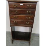 An Edwardian mahogany music cabinet, the four long drawers with hinged fronts and gilt brass