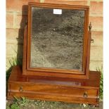 A Georgian mahogany swing vanity mirror with brass finials, above a box base with single drawer,