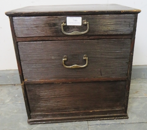 A vintage Japanese miniature ebonised tansu chest, of two bamboo-lined drawers with steel drop