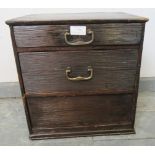 A vintage Japanese miniature ebonised tansu chest, of two bamboo-lined drawers with steel drop