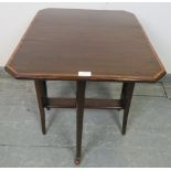 An Edwardian mahogany Sutherland table, with crossbanded inlay, on square supports with ceramic